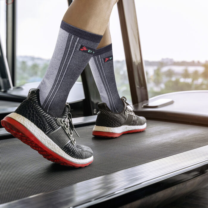 Male feet in sneakers running on the treadmill at the gym. Exerc