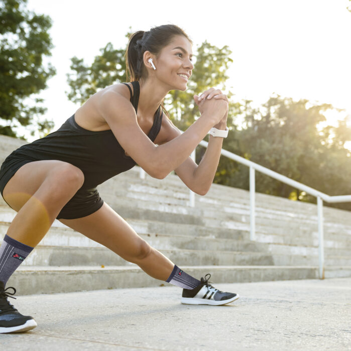 Portrait of a smiling fitness woman in earphones